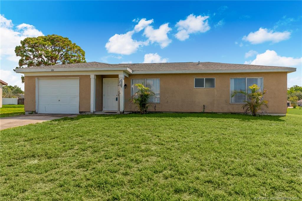 255 Southwest Homeland Road Port St. Lucie, FL 34953 - Photo 14 of 15 a view of a house with a garden