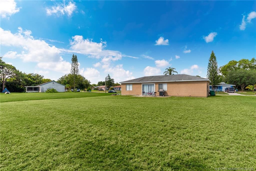 255 Southwest Homeland Road Port St. Lucie, FL 34953 - Photo 2 of 15 a front view of a house with garden