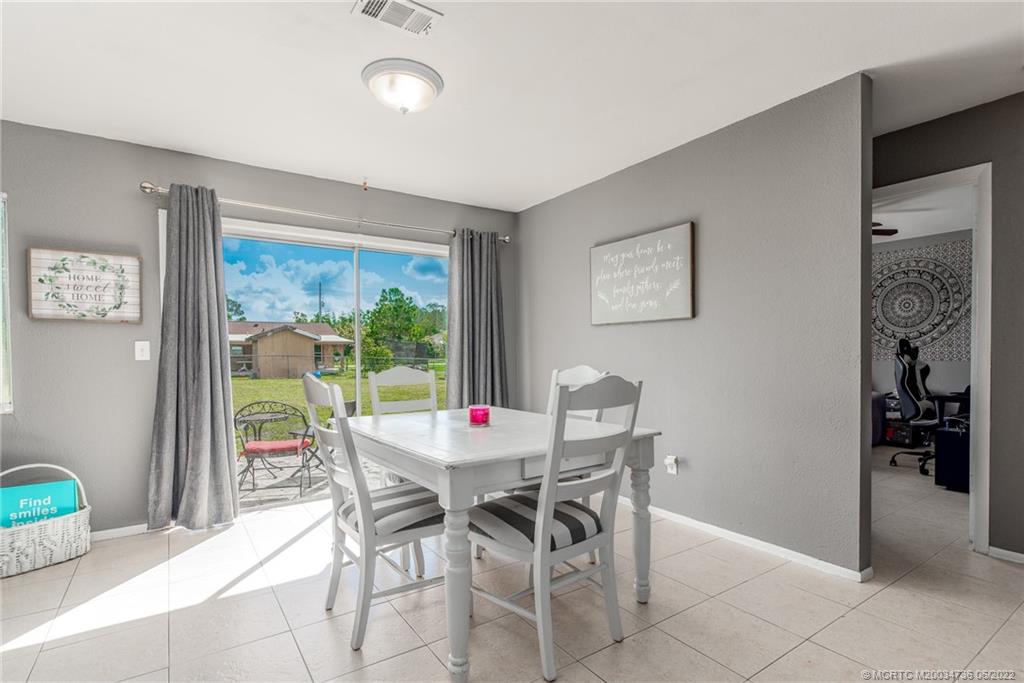 255 Southwest Homeland Road Port St. Lucie, FL 34953 - Photo 3 of 15 a view of a dining room with furniture window and outside view
