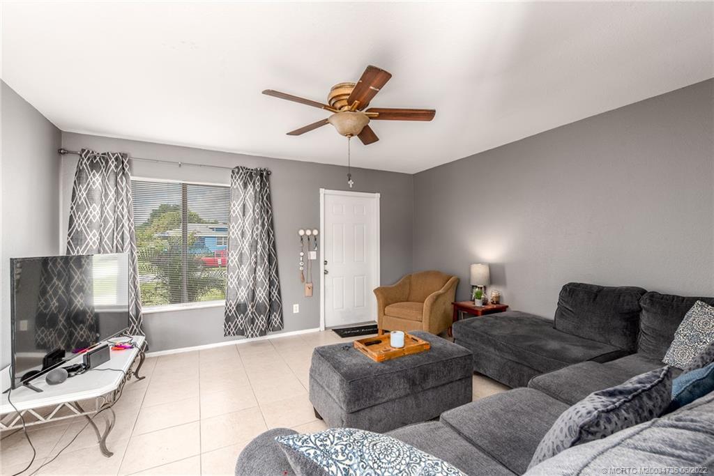 255 Southwest Homeland Road Port St. Lucie, FL 34953 - Photo 5 of 15 a bedroom with furniture and a fireplace