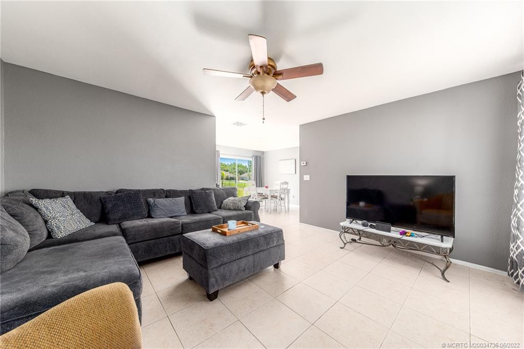 255 Southwest Homeland Road Port St. Lucie, FL 34953 - Photo 6 of 15 a living room with furniture and a flat screen tv