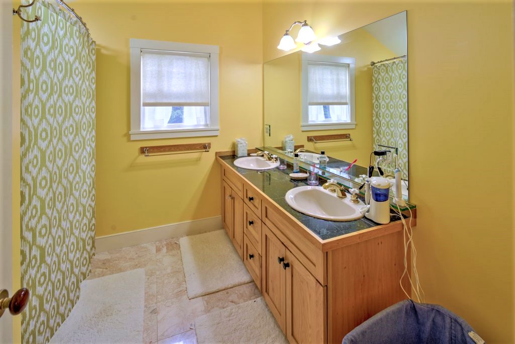 16 Meshacket Road Edgartown, MA 02539 - Photo 26 of 41 a bathroom with a sink a mirror and a bathtub