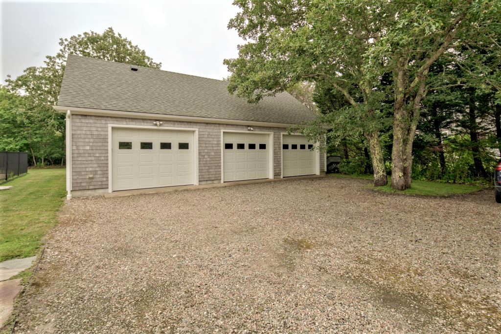 16 Meshacket Road Edgartown, MA 02539 - Photo 33 of 41 a house with trees in front of it
