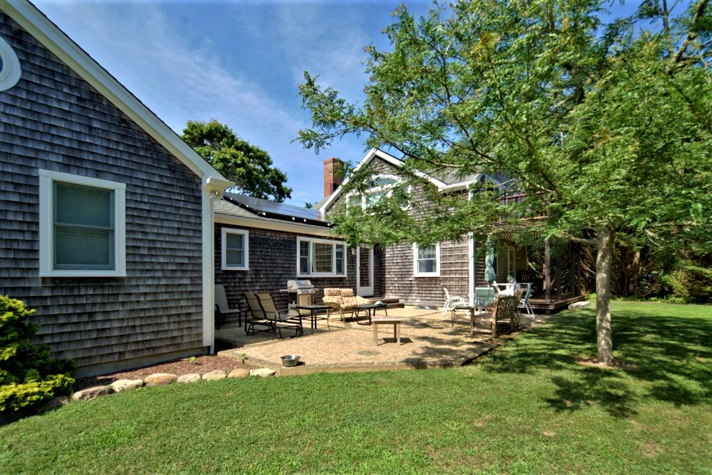16 Meshacket Road Edgartown, MA 02539 - Photo 36 of 41 a view of a house with backyard porch and sitting area