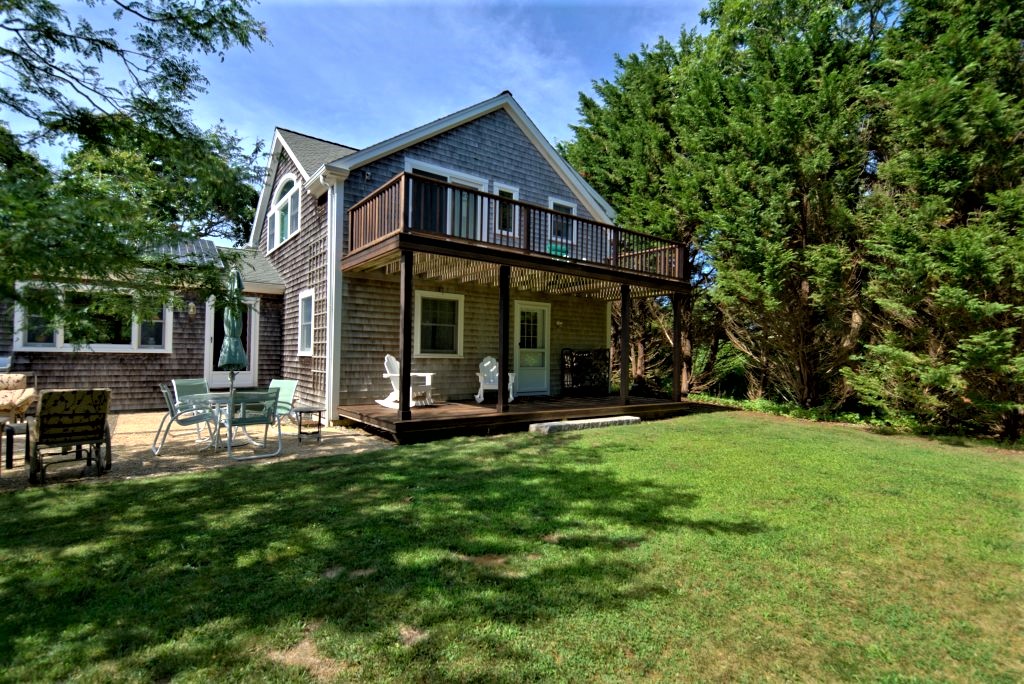 16 Meshacket Road Edgartown, MA 02539 - Photo 38 of 41 a view of a house with a yard porch and sitting area