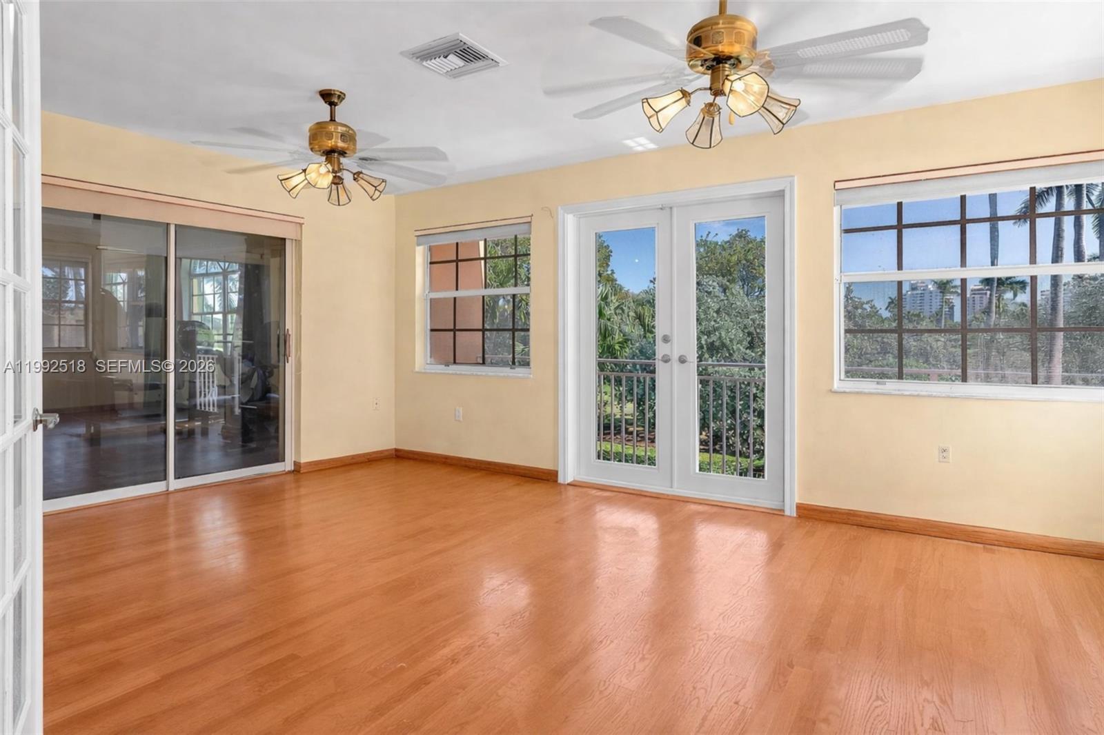 5309 Alton Road Miami Beach, FL 33140 - Photo 16 of 51 a view of an empty room with a window and wooden floor
