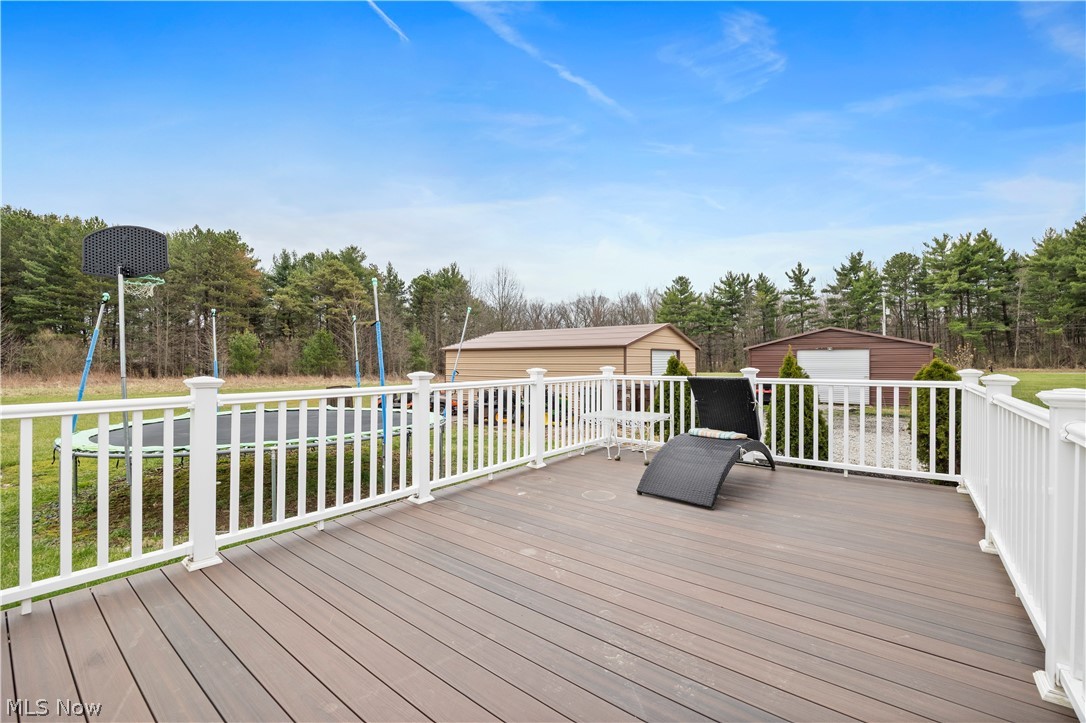 36220 Neff Road Grafton, OH 44044 - Photo 43 of 50 Deck featuring an outbuilding, a lawn, and view of wooded area