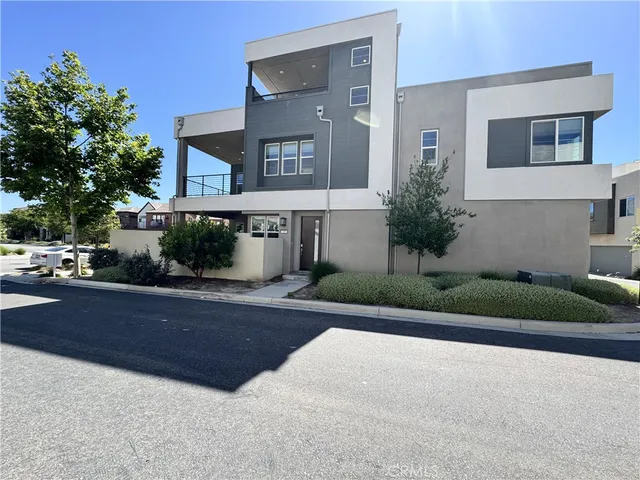 a front view of a house with a yard and a garage