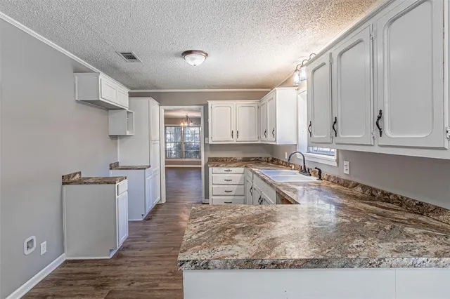 a kitchen with stainless steel appliances granite countertop a sink stove and cabinets