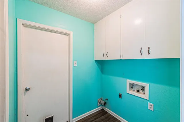 a view of a room that has a fan and a window with wooden floor
