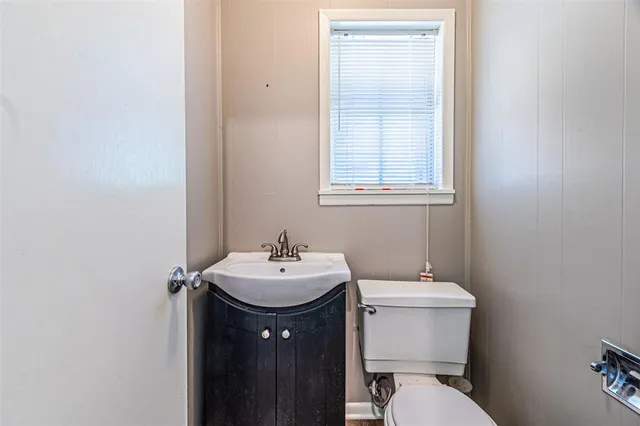 a bathroom with a sink toilet and a mirror