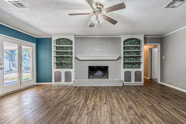 a view of a livingroom with a fireplace and window