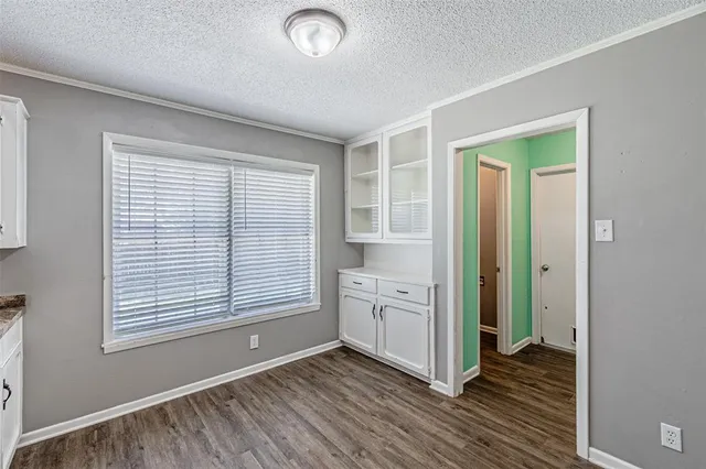 a view of a room with wooden floor and cabinet