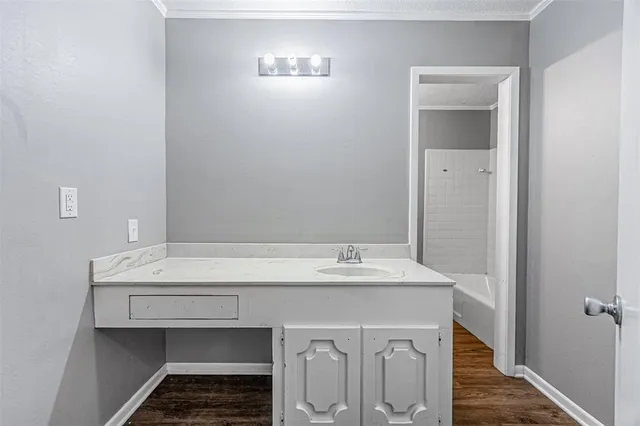 a white toilet sitting next to a white tub