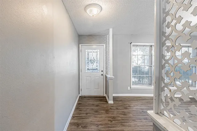a view of a livingroom with wooden floor and a window