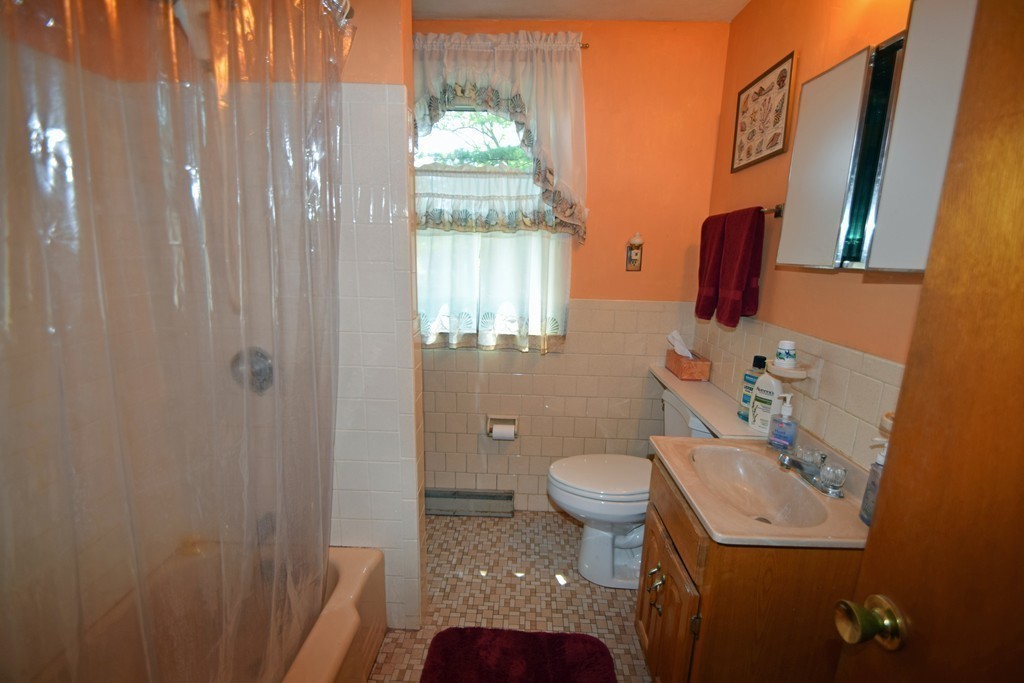 33 Clark Street, Unit A Randolph, MA 02368 - Photo 12 of 15 a bathroom with a sink toilet and shower