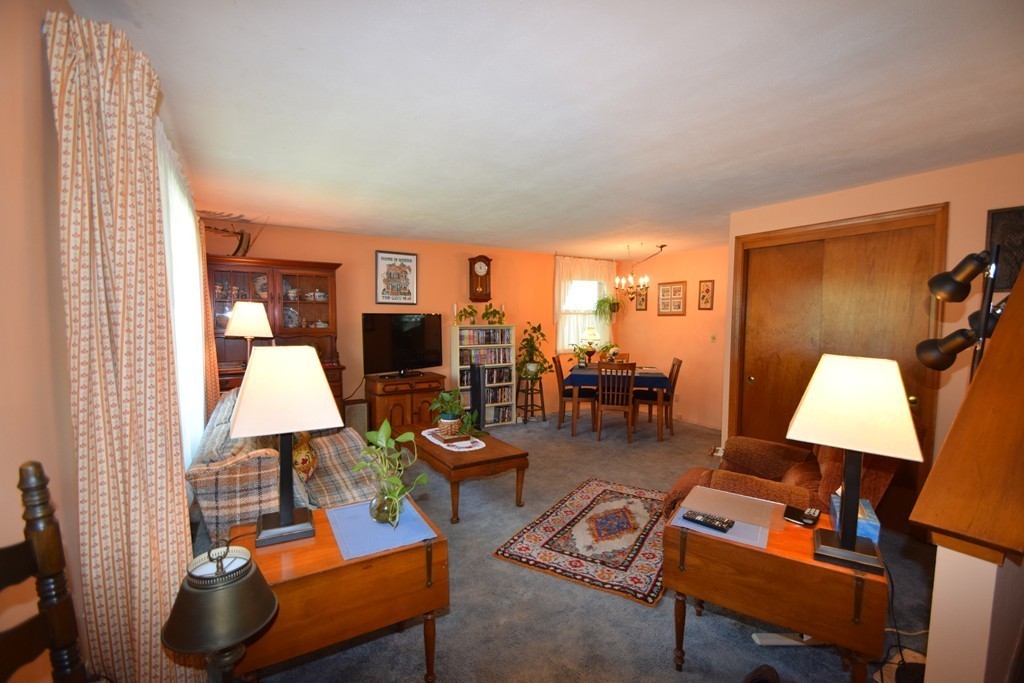 33 Clark Street, Unit A Randolph, MA 02368 - Photo 2 of 15 a living room with furniture a rug and a lamp