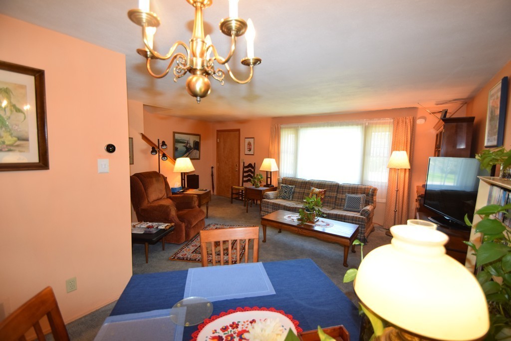 33 Clark Street, Unit A Randolph, MA 02368 - Photo 3 of 15 a living room with fireplace furniture and a large window