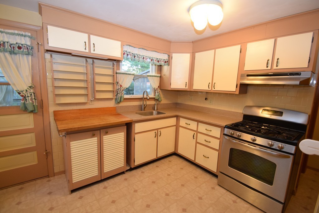 33 Clark Street, Unit A Randolph, MA 02368 - Photo 4 of 15 a kitchen with a stove a sink and a window