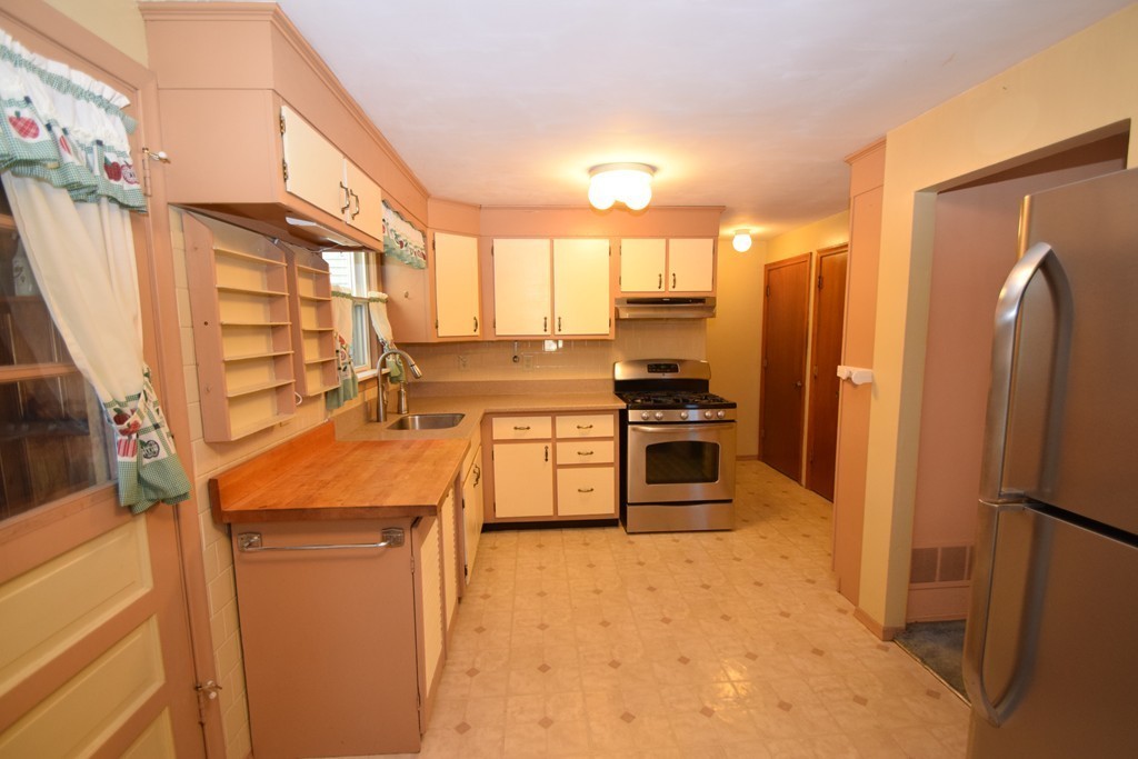 33 Clark Street, Unit A Randolph, MA 02368 - Photo 5 of 15 a kitchen with stainless steel appliances a refrigerator a stove a sink and a refrigerator