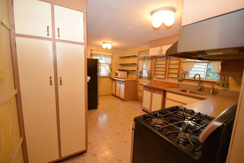 33 Clark Street, Unit A Randolph, MA 02368 - Photo 7 of 15 a kitchen with a stove and a refrigerator