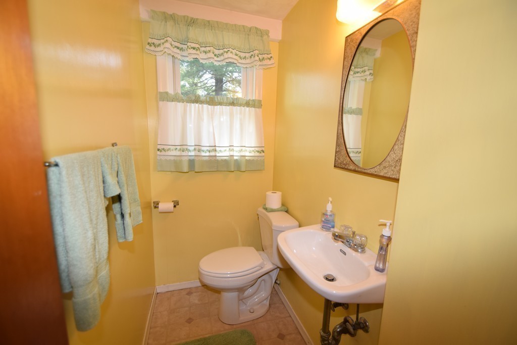 33 Clark Street, Unit A Randolph, MA 02368 - Photo 8 of 15 a bathroom with a toilet sink and mirror