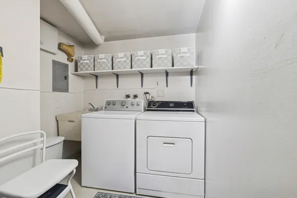 a utility room with cabinets washer and dryer