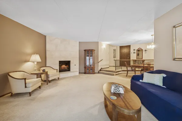 a living room with furniture a lamp and a fireplace