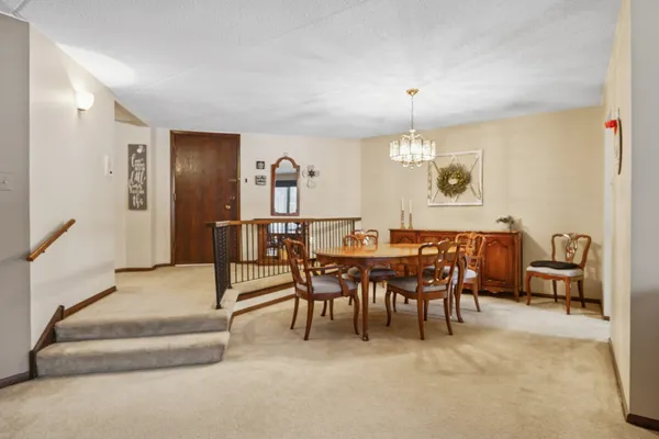 a dining room with furniture and a chandelier
