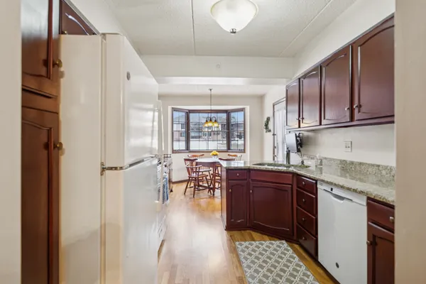 a kitchen with stainless steel appliances granite countertop a refrigerator and a stove top oven