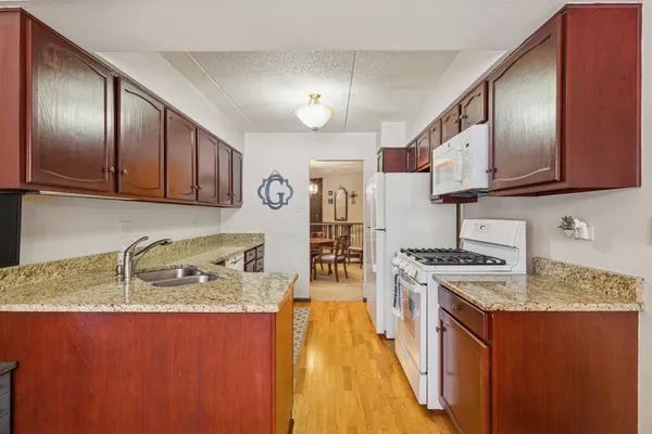 a kitchen with stainless steel appliances granite countertop a sink stove and cabinets