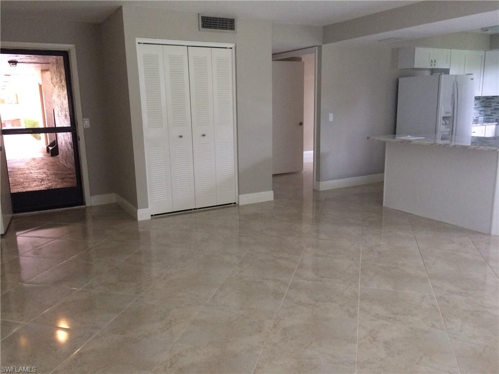3655 Boca Ciega Drive, Unit 102 Naples, FL 34112 - Photo 14 of 27 an empty room with windows and entrance to room
