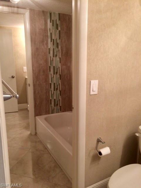 3655 Boca Ciega Drive, Unit 102 Naples, FL 34112 - Photo 22 of 27 a bathroom with a shower and a toilet