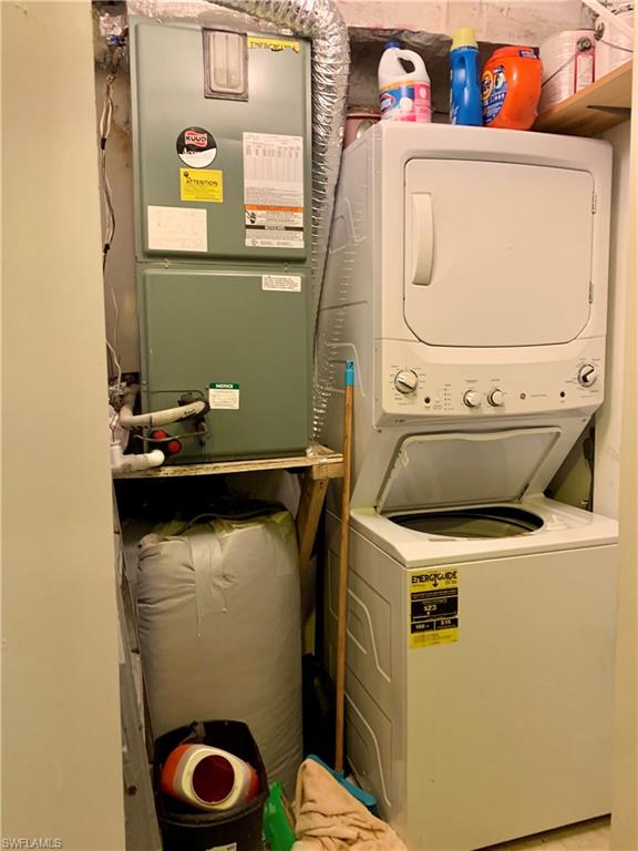 3655 Boca Ciega Drive, Unit 102 Naples, FL 34112 - Photo 23 of 27 a utility room with dryer and washer