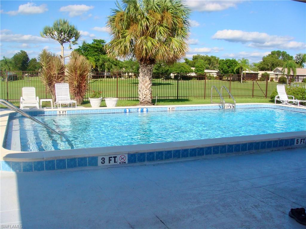 3655 Boca Ciega Drive, Unit 102 Naples, FL 34112 - Photo 25 of 27 a view of swimming pool with a yard and sitting space