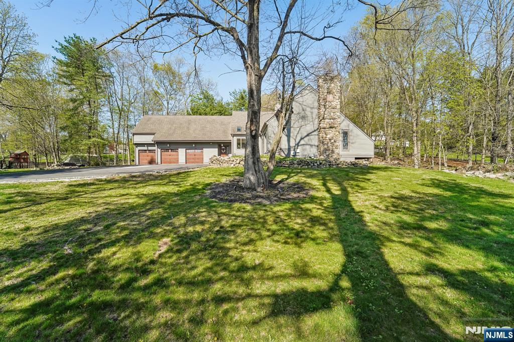 11 Carlough Road Upper Saddle River, NJ 07458 - Photo 40 of 41 a backyard of a house with lots of green space
