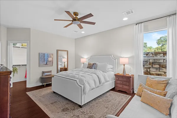 a bedroom with a large bed and a chandelier