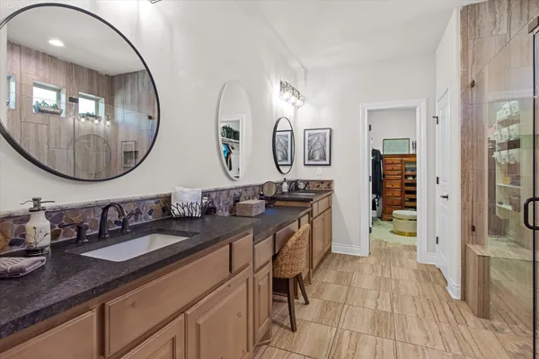 a spacious bathroom with a double vanity sink and a mirror