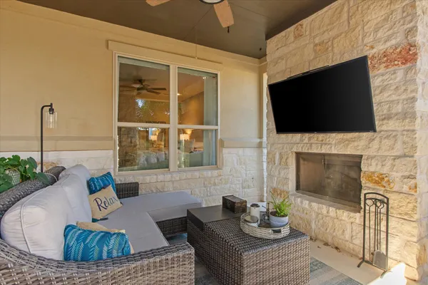 a living room with furniture a fireplace and a flat screen tv