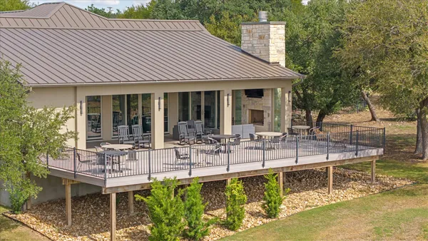 a view of house with swimming pool and chairs