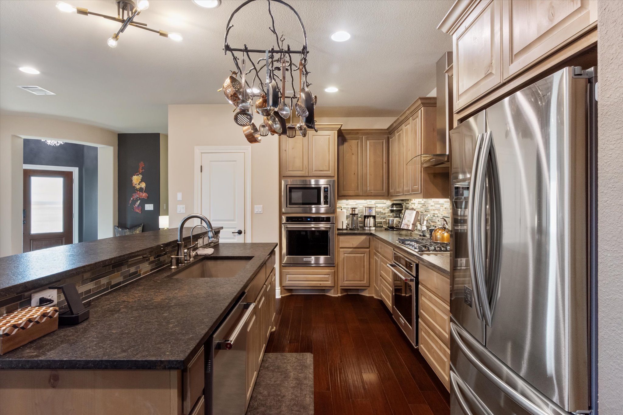549 Clubhouse Drive, Unit G Georgetown, TX 78628 - Photo 6 of 35 a kitchen with kitchen island stainless steel appliances a sink stove and refrigerator