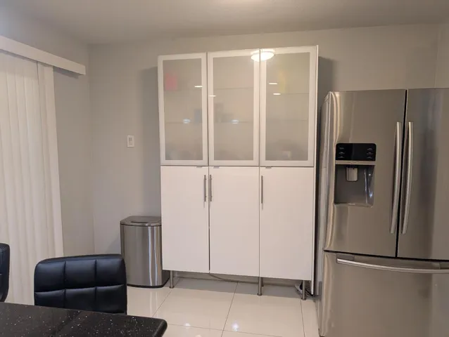 a view of livingroom with furniture and refrigerator