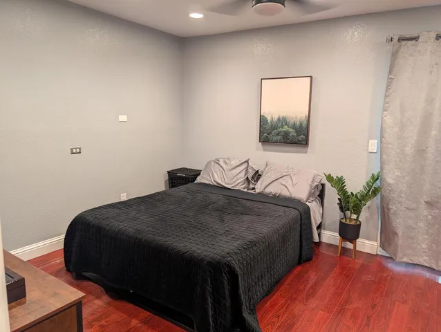 a bedroom with bed and a potted plant