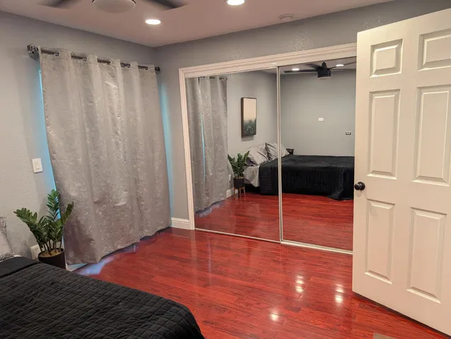 a bedroom with a bed and a plant