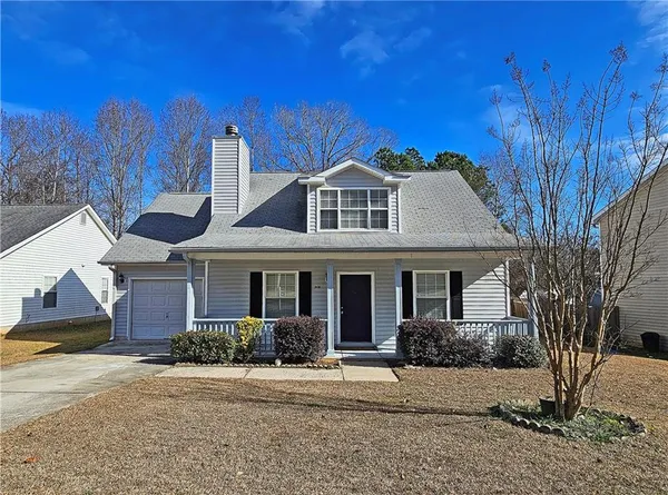 a front view of a house with a yard