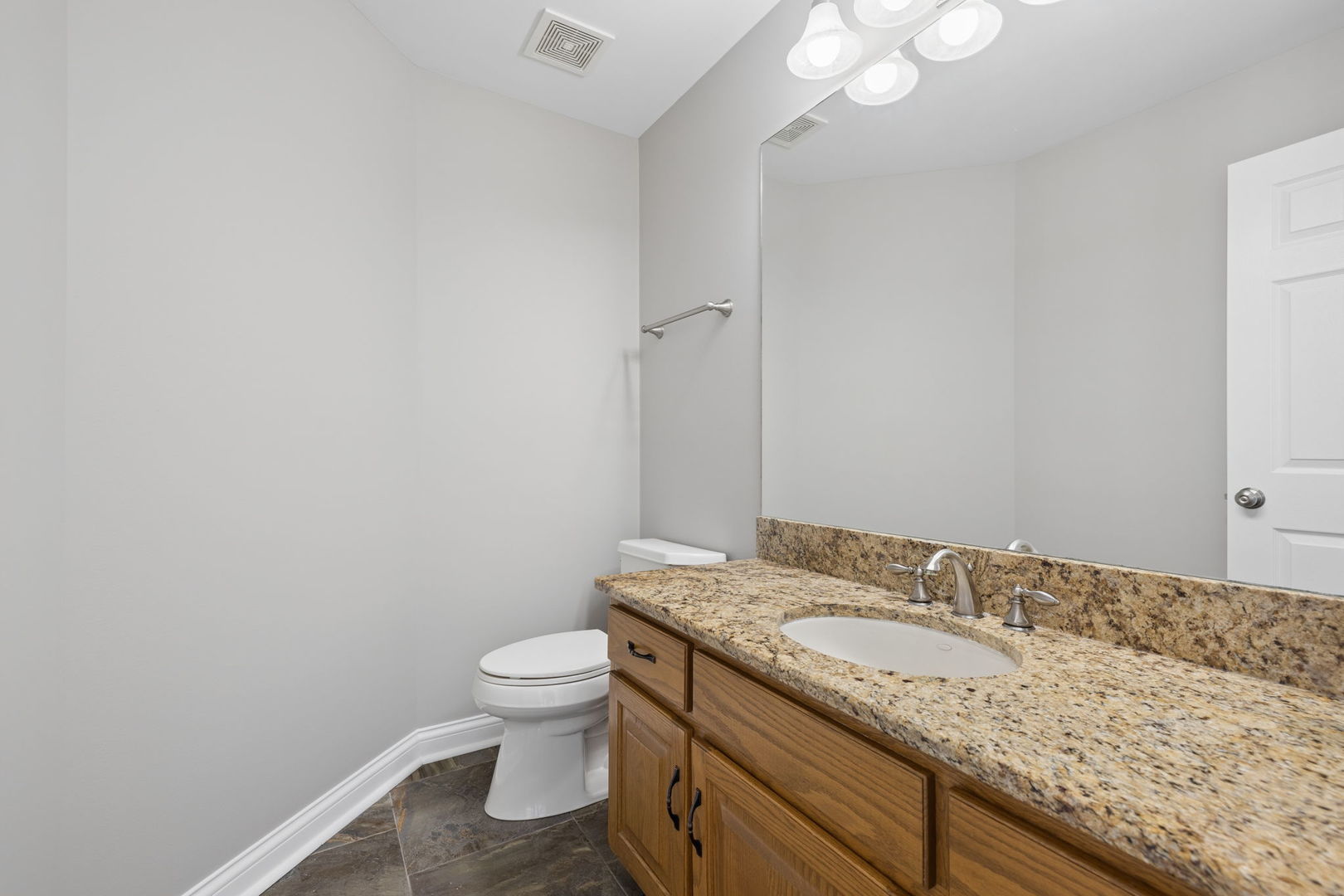 1336 Tralee Lane Lockport, IL 60441 - Photo 11 of 35 a bathroom with a granite countertop sink a toilet and a mirror