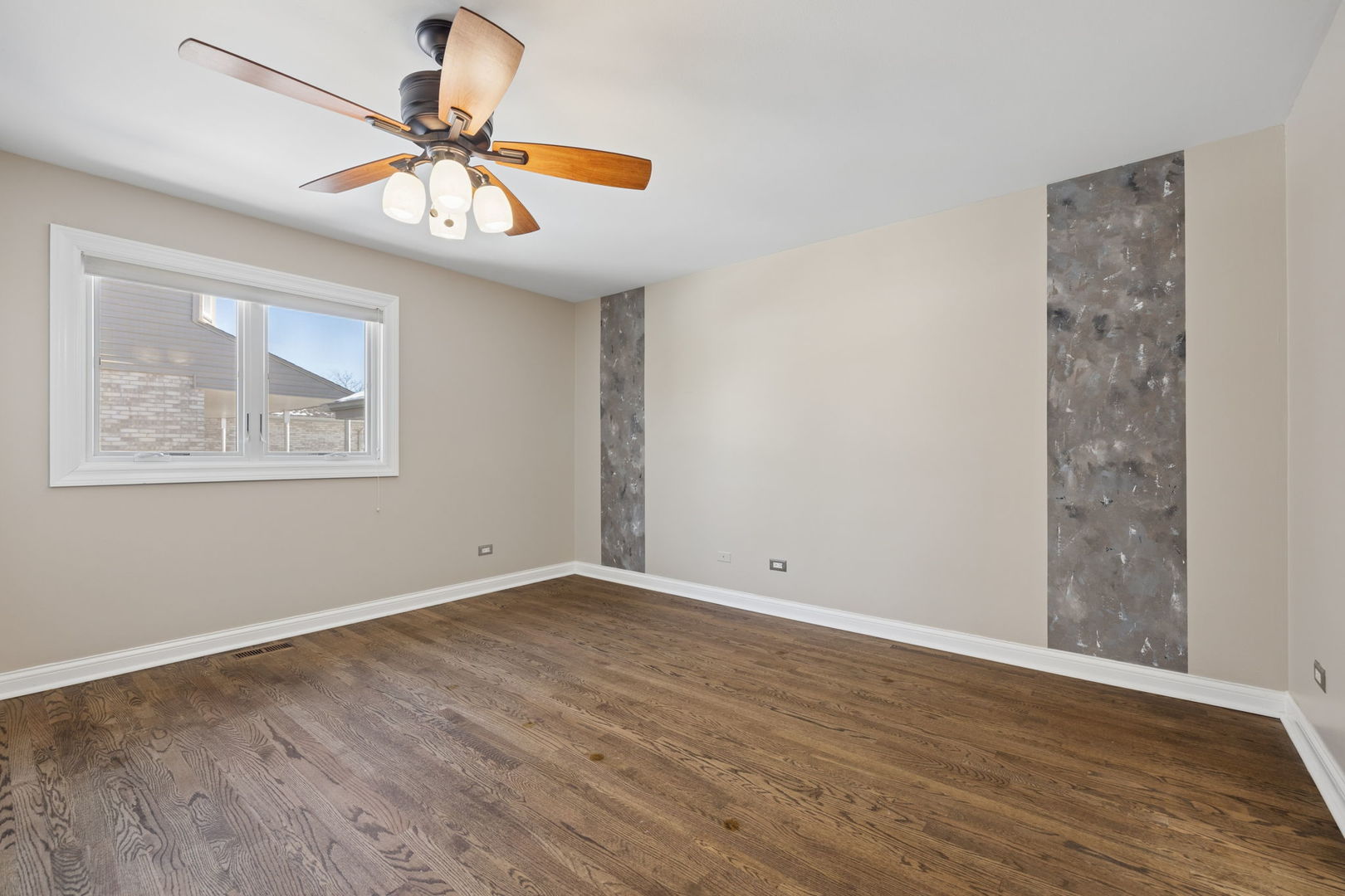 1336 Tralee Lane Lockport, IL 60441 - Photo 13 of 35 a view of an empty room with wooden floor and a fan