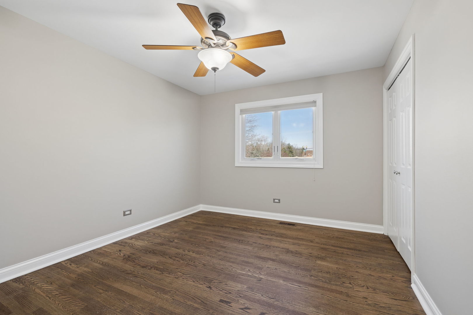 1336 Tralee Lane Lockport, IL 60441 - Photo 18 of 35 an empty room with wooden floor and ceiling fan
