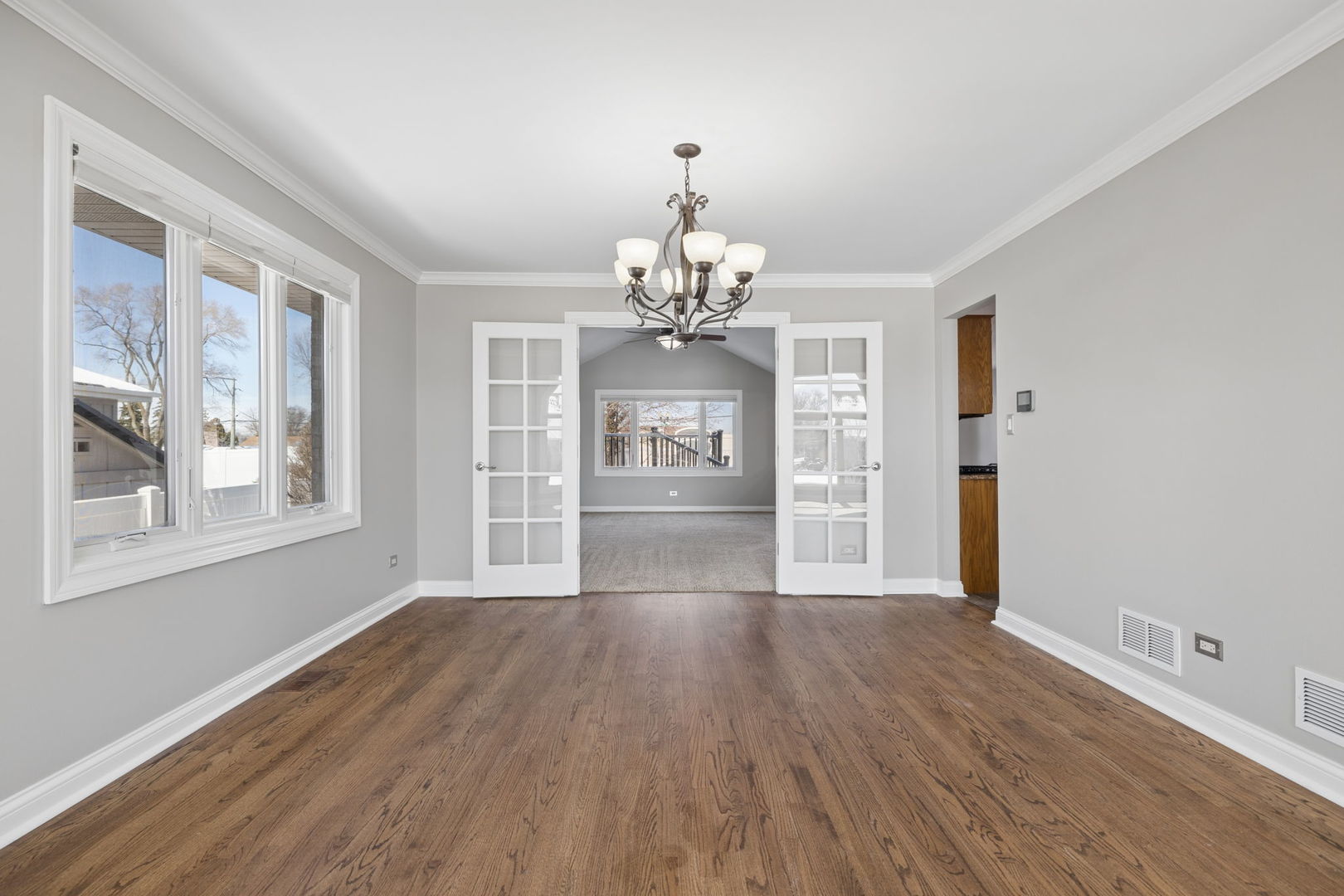 1336 Tralee Lane Lockport, IL 60441 - Photo 5 of 35 a view of an empty room with wooden floor and a window