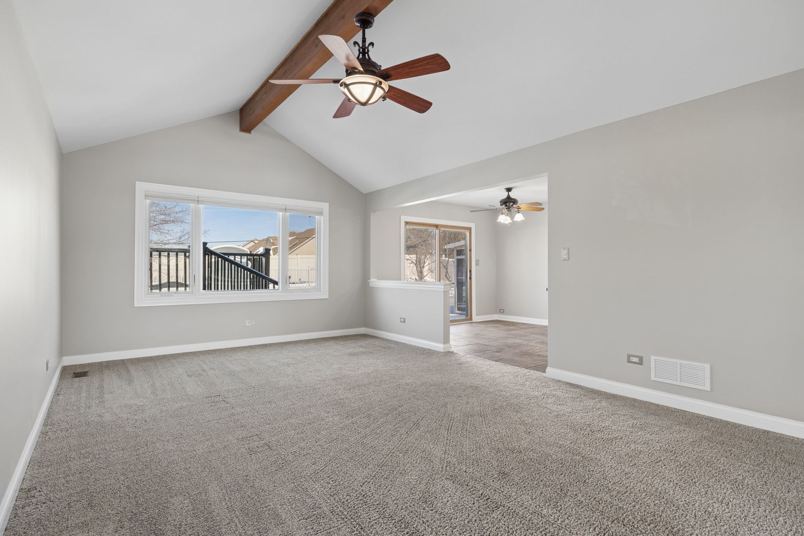 1336 Tralee Lane Lockport, IL 60441 - Photo 9 of 35 an empty room with chandelier fan and windows
